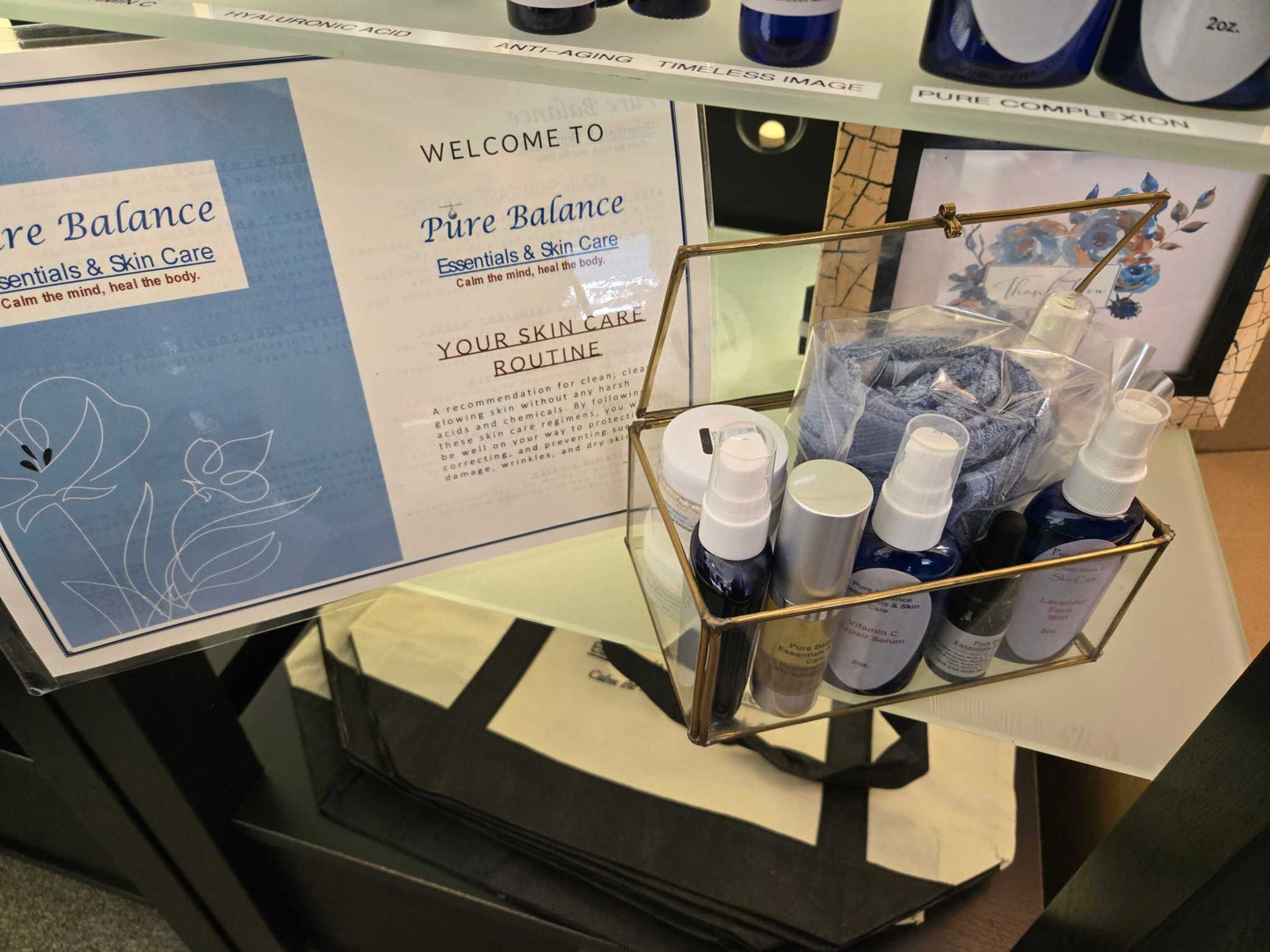 100% cotton ring spun wash cloth with skin care products in a display, featuring varying colors of grey and blue.