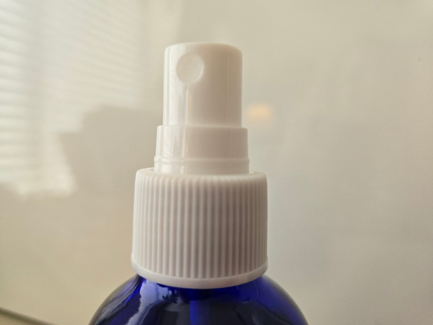Blue spray bottle of 3 B's natural air freshener with white nozzle, 4 ounces.