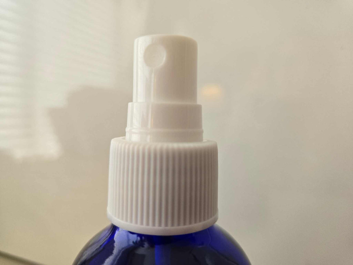 Blue spray bottle of 3 B's natural air freshener with white nozzle, 4 ounces.