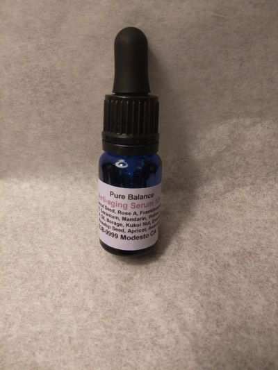 10ml anti-aging serum bottle with dropper, hydrating and repairing facial product containing essential oils.