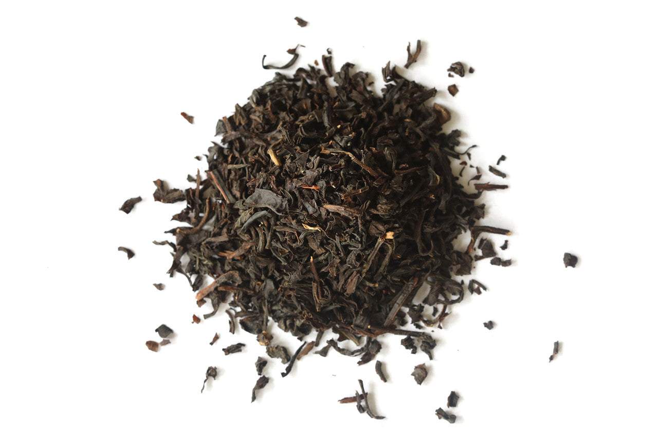 Loose English Breakfast Tea leaves on a white background.