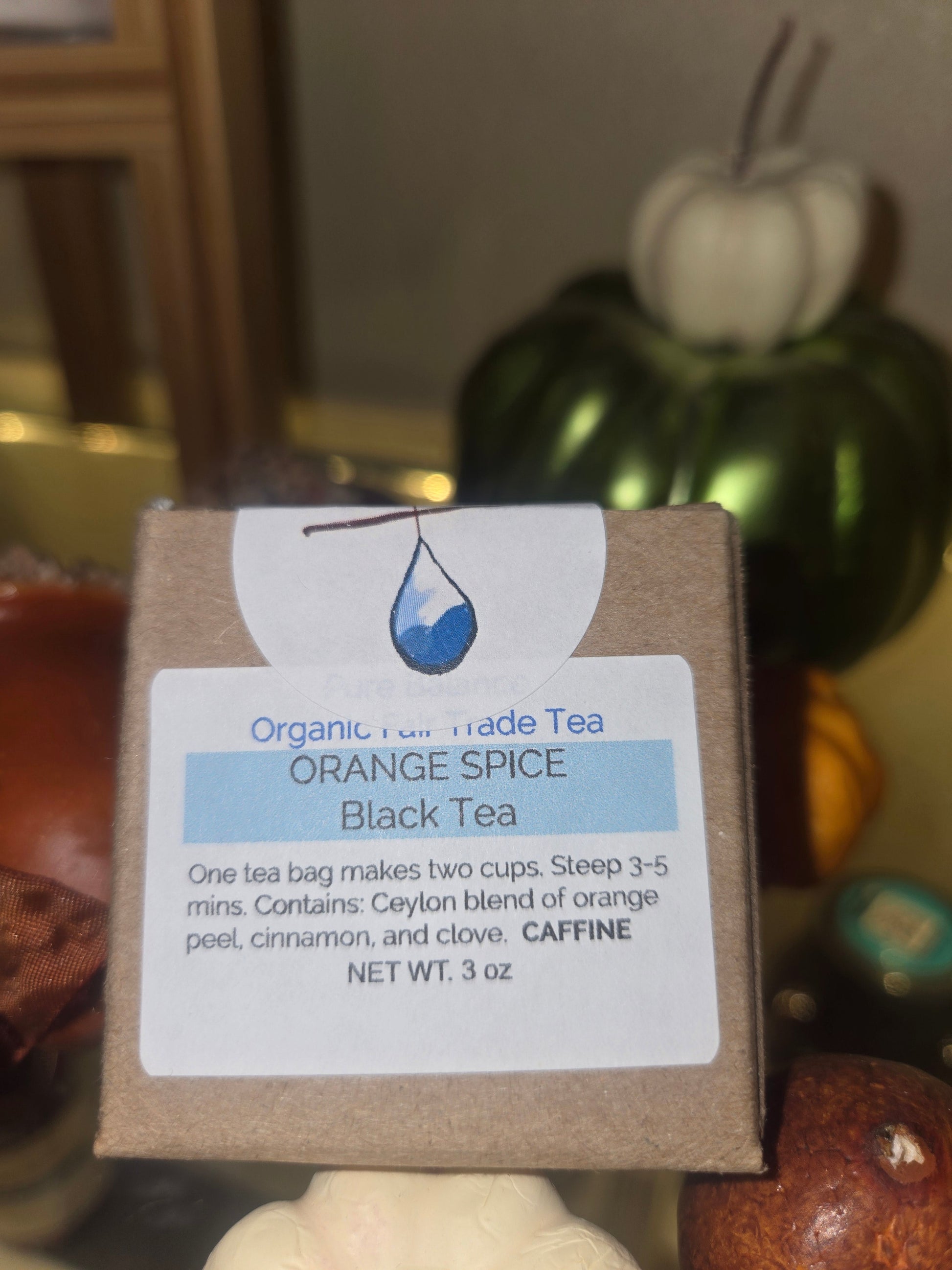 Cup of Orange Spice Tea with orange peel, cinnamon, and clove on wooden table